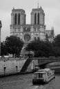 Tourist boat floats on the channel near Notre Dame de Paris. Royalty Free Stock Photo